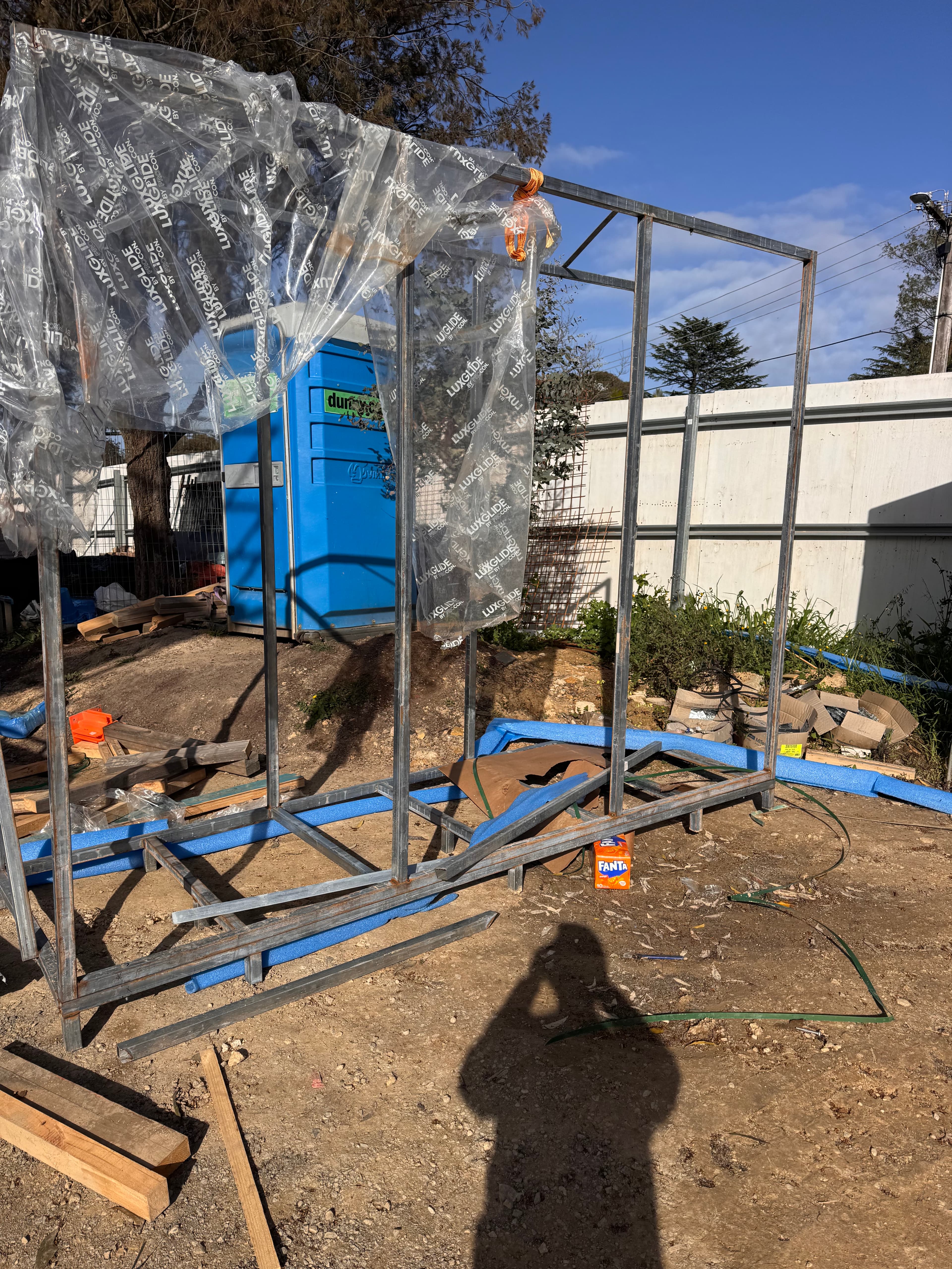 Steel frame structure with plastic sheeting